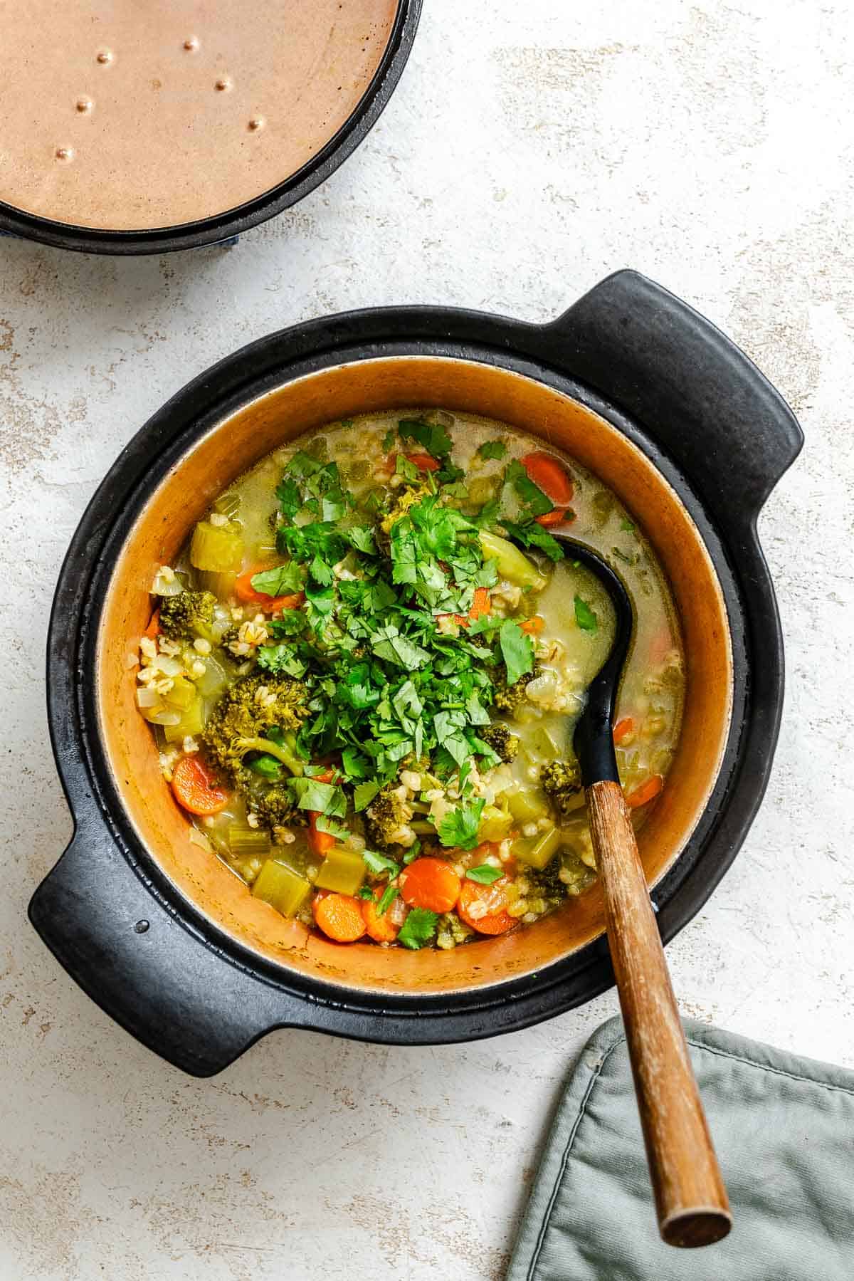 Process shot showing veggies cooking in pot.
