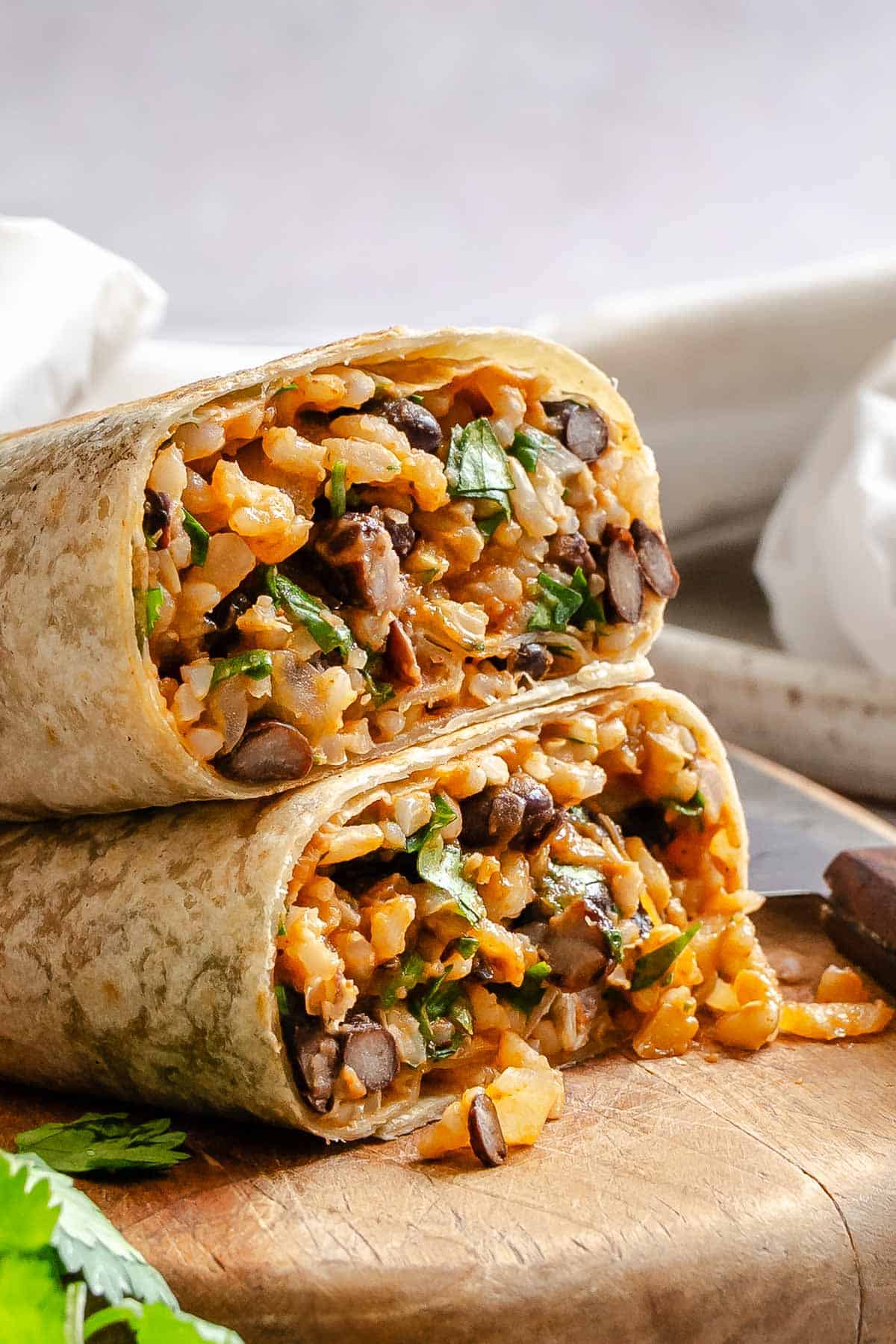 Two completed Rice and Black Bean Burrito (Freezer Friendly) stacked on one another.