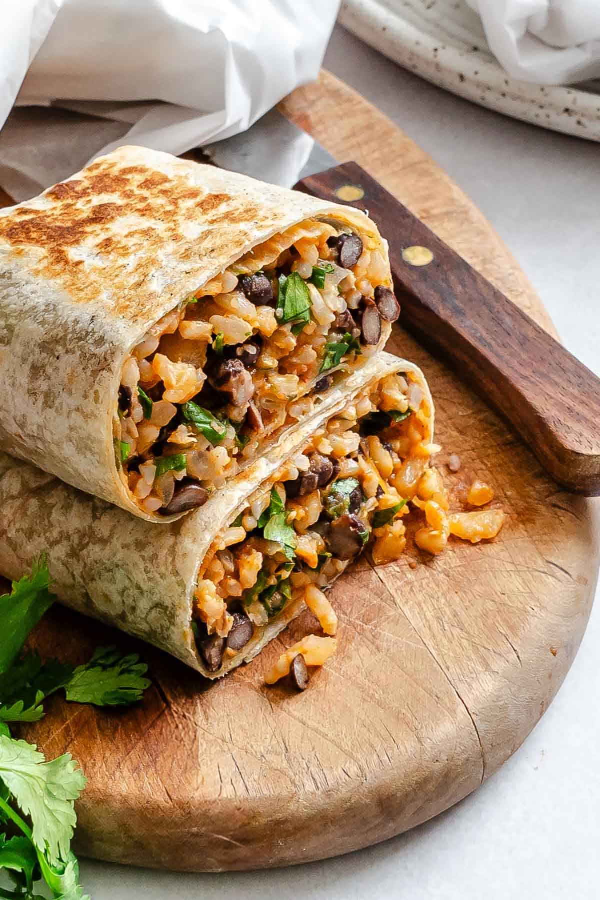 Two completed Rice and Black Bean Burrito (Freezer Friendly) stacked on one another.