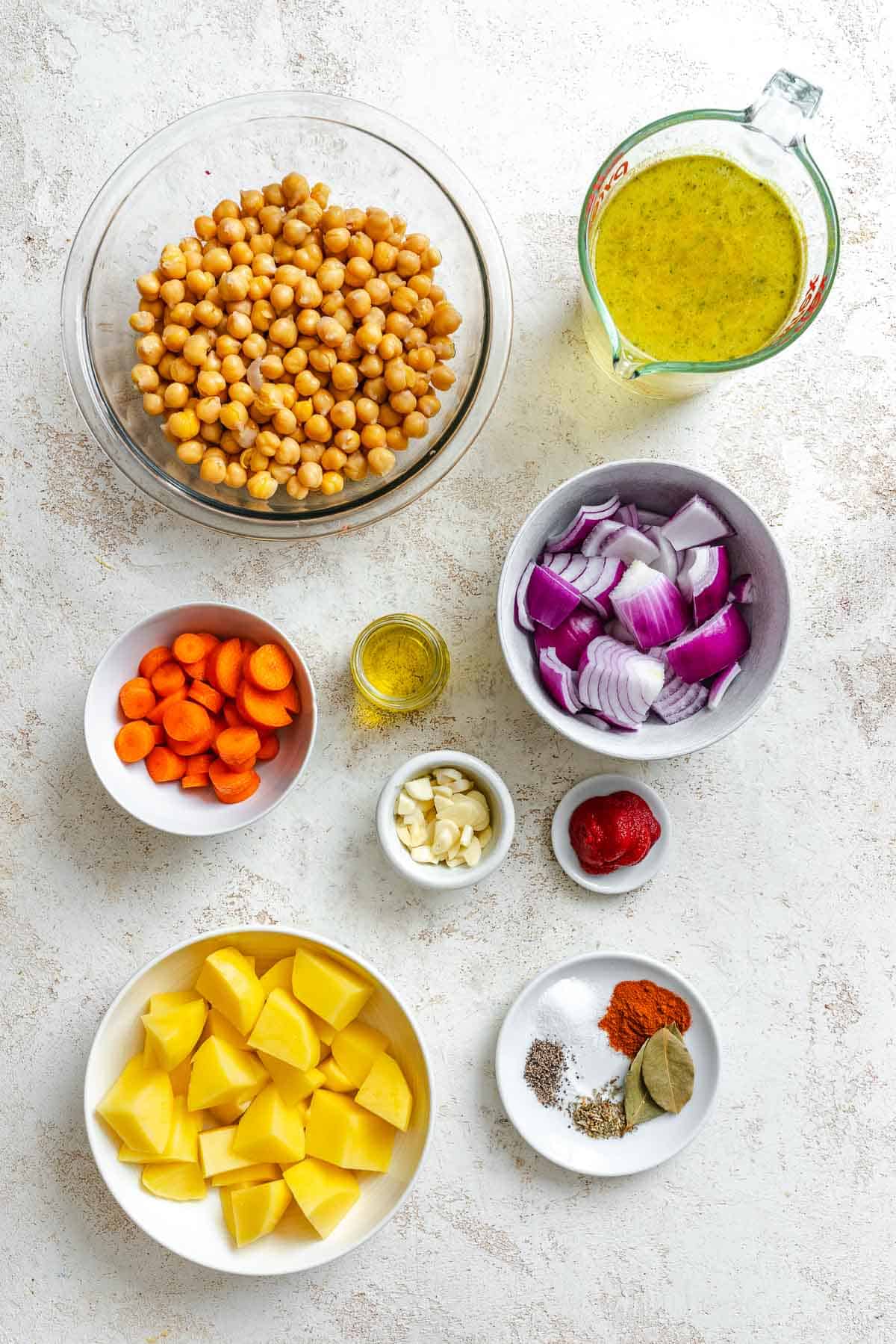 Ingredients for Chickpea Stew measured out on a white surface.