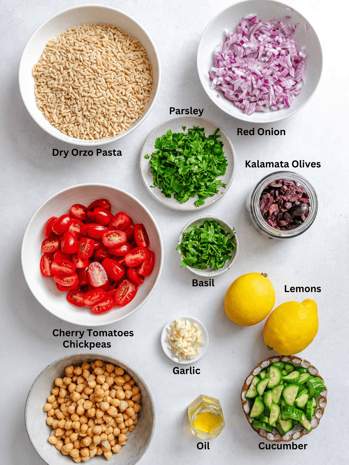 Ingredients for Easy Lemon Orzo Salad measured out on a white surface.