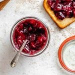 Completed Easy Plum Jam (No Pectin) in a jar and spread on bread.