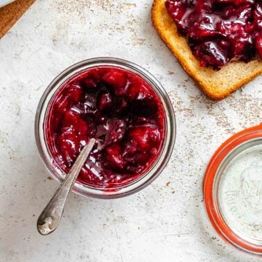 Completed Easy Plum Jam (No Pectin) in a jar and spread on bread.