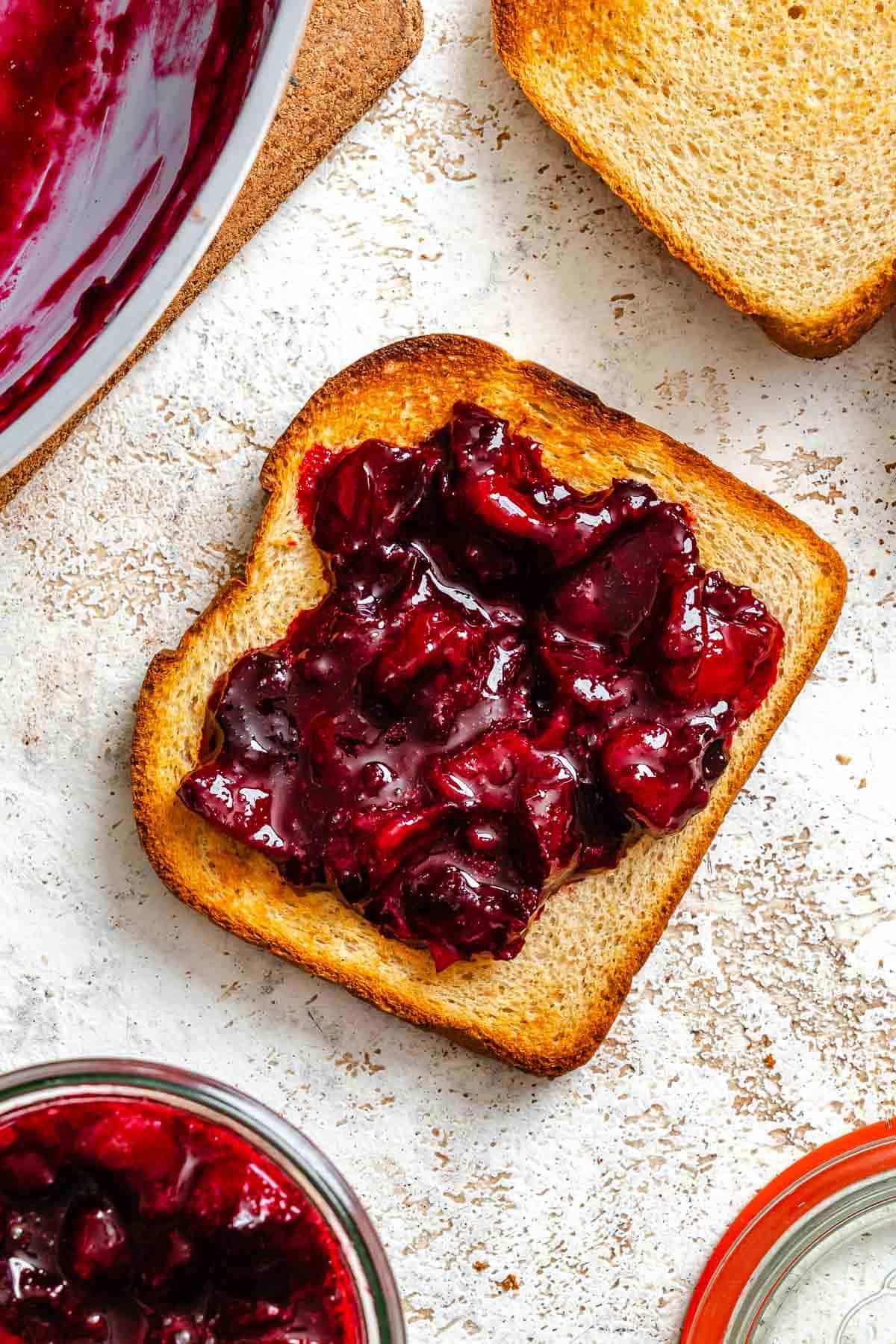 Completed Easy Plum Jam (No Pectin) spread onto a piece of bread.
