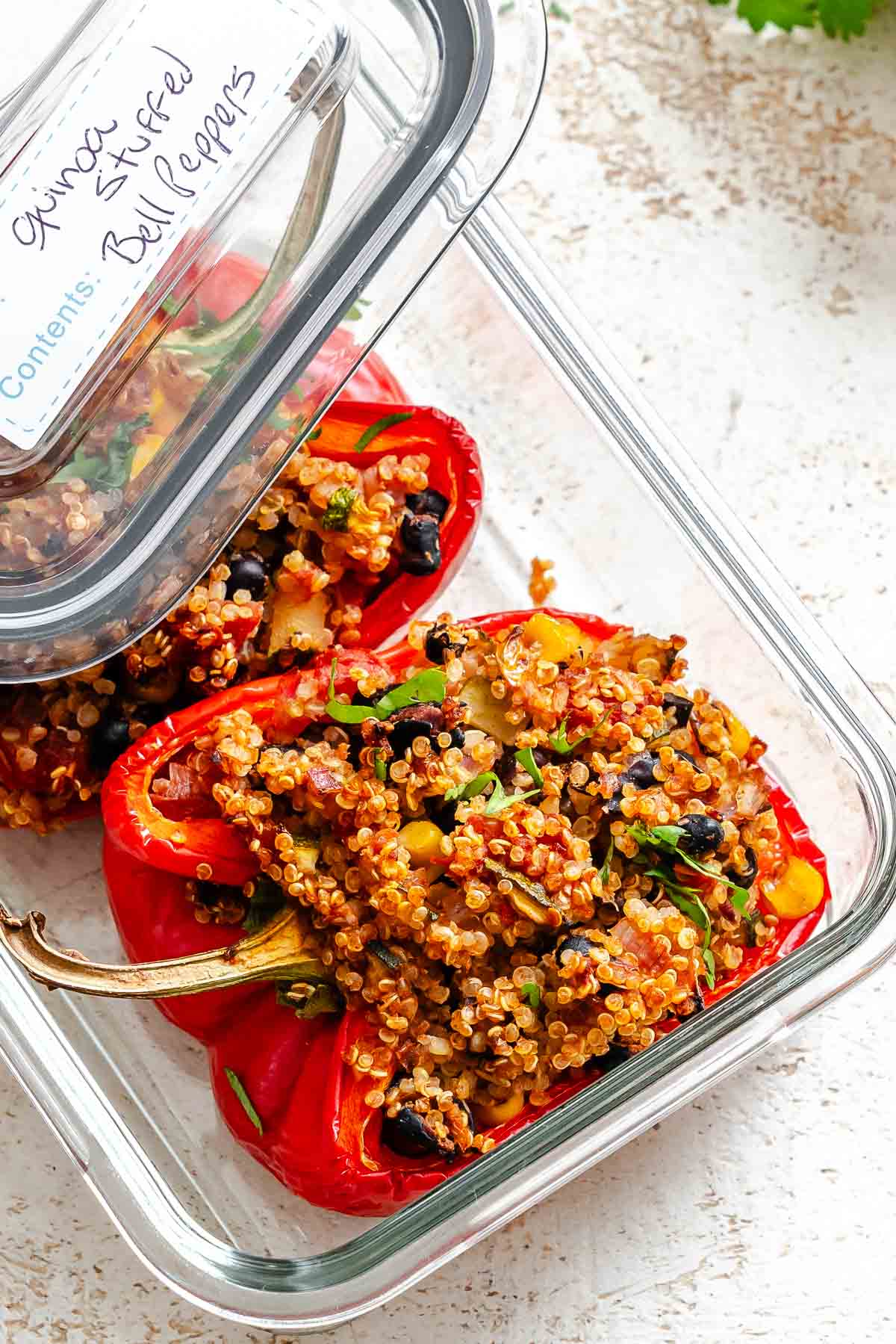 Completed Quinoa Stuffed Bell Peppers in a storage container.