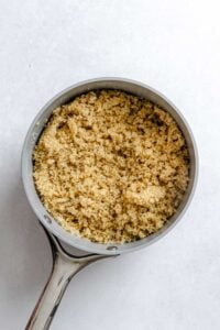 Process shot showing quinoa cooking in pan.