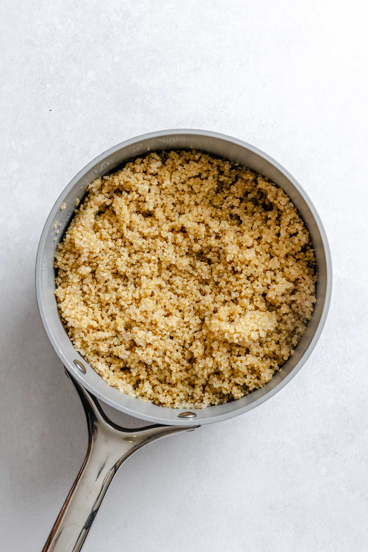 Process shot showing quinoa cooking in pan.