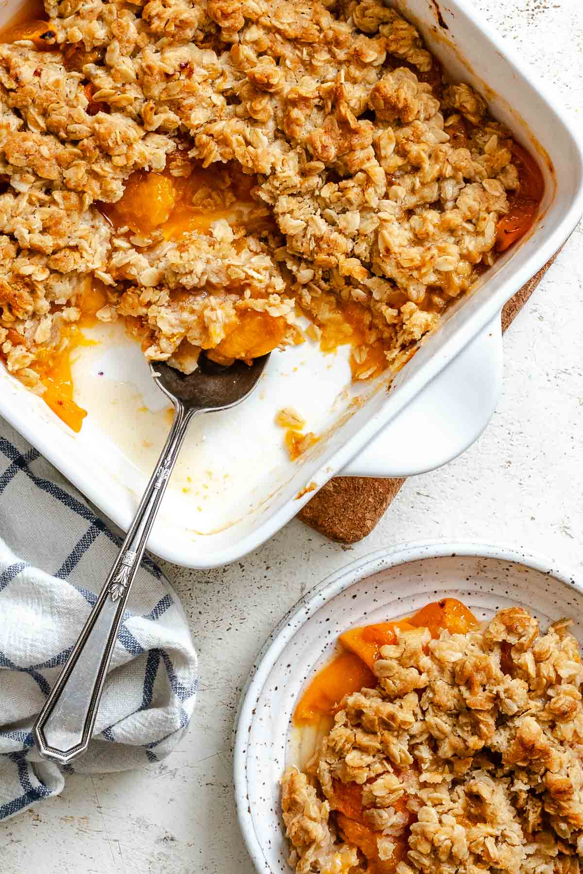 Completed Easy Apricot Crumble (With Oats) in baking dish and plate.