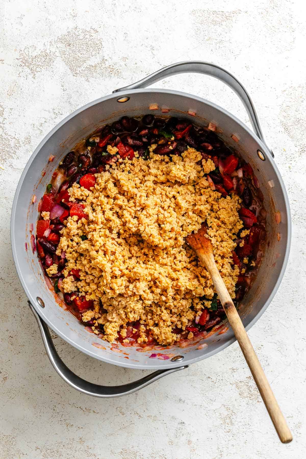 Process shot showing stirring ingredients in a pot.