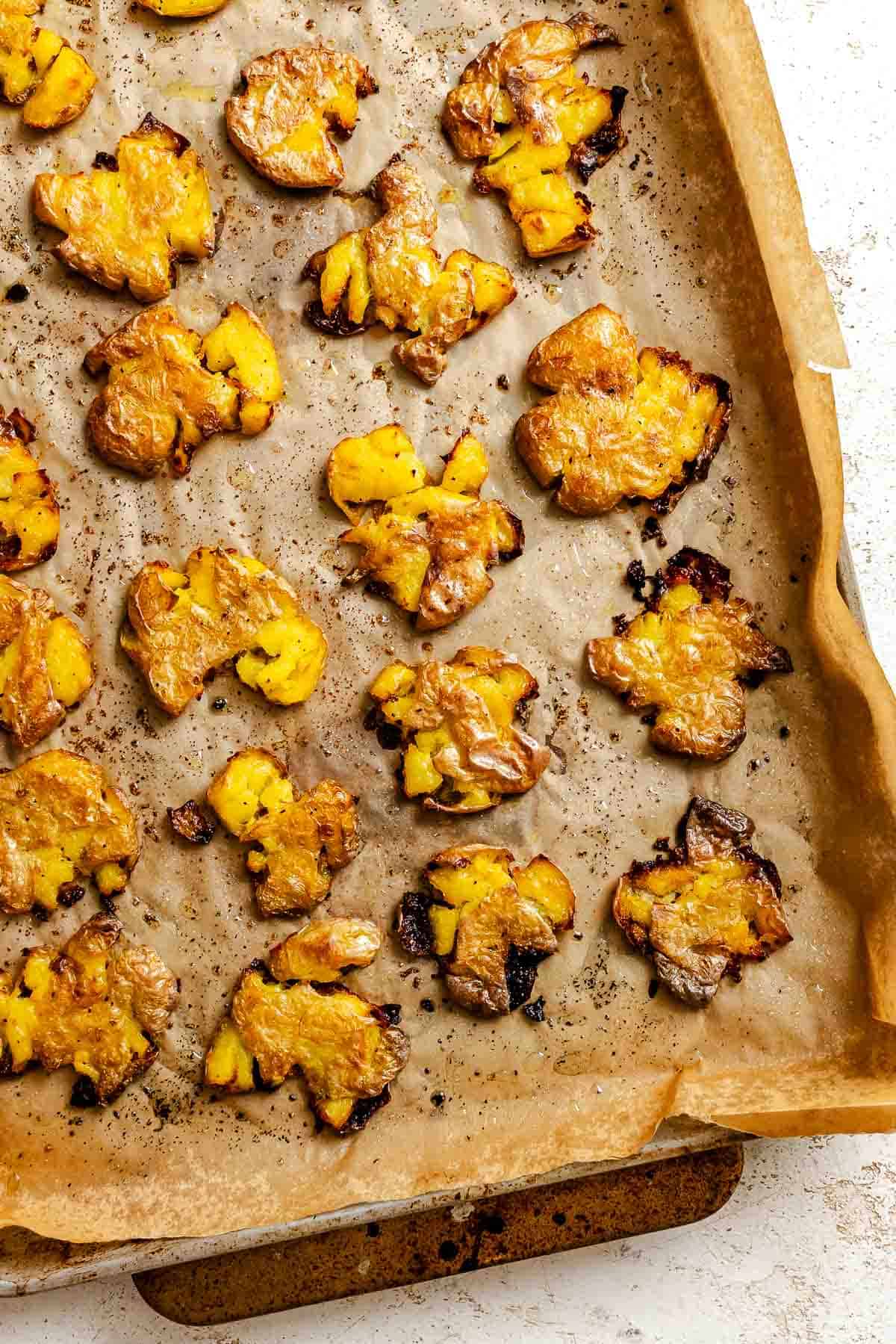 Process shot showing post baked potatoes on baking dish.