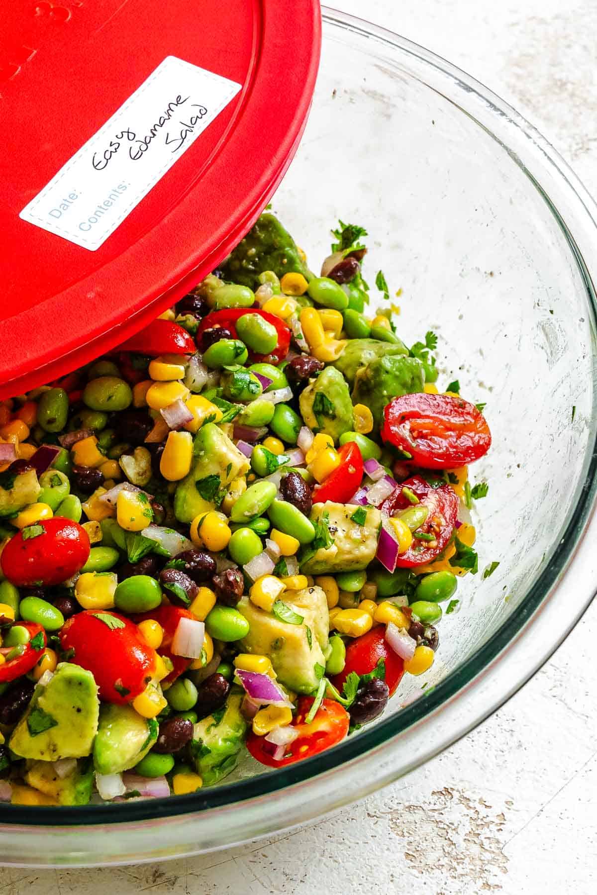 Completed Edamame Salad (With Corn and Black Beans) in a storage bowl. 