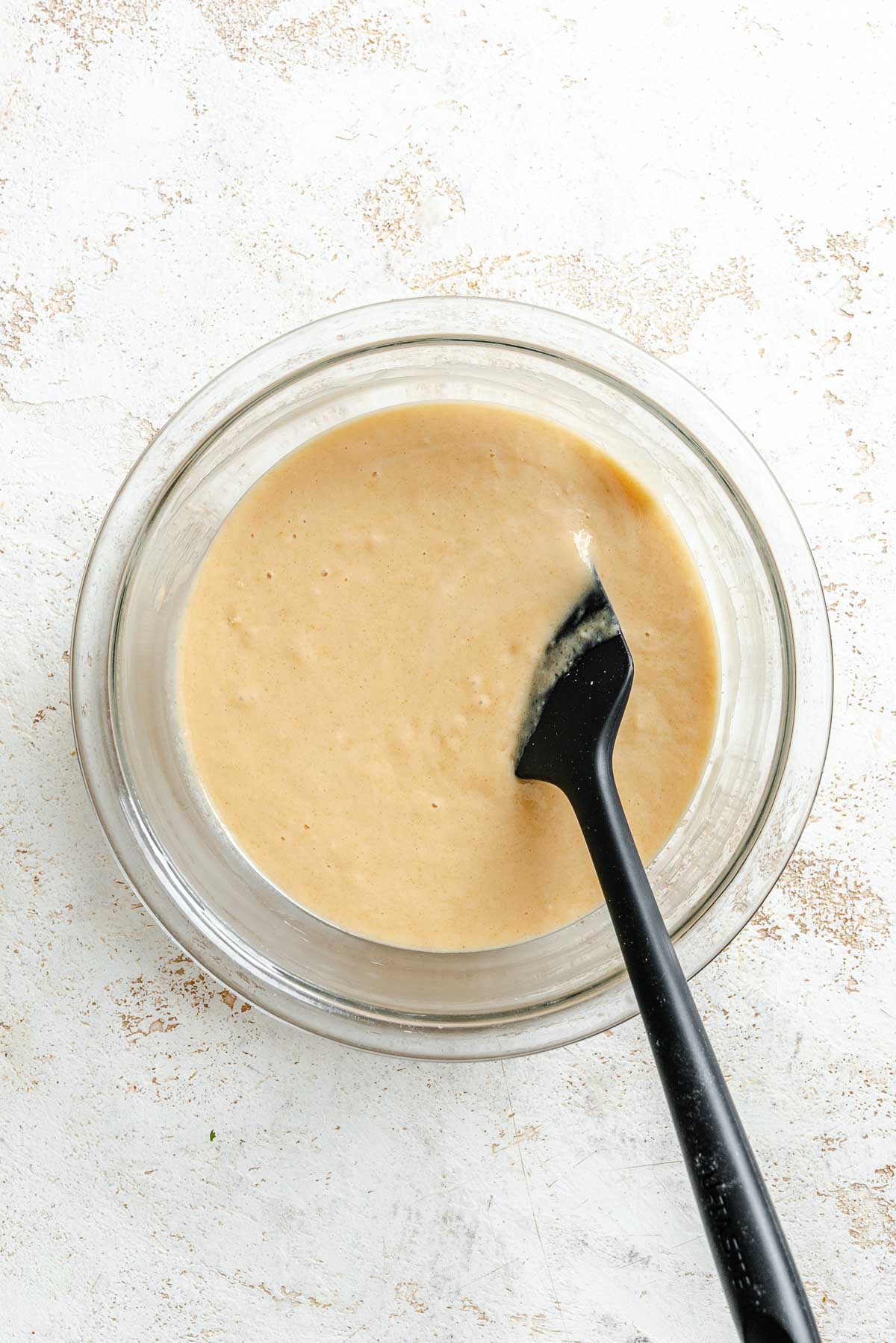 Process shot showing mixing ingredients in a bowl.