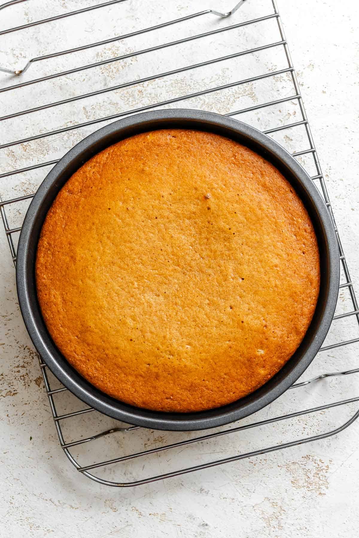 Process shot show cake cooling on rack.