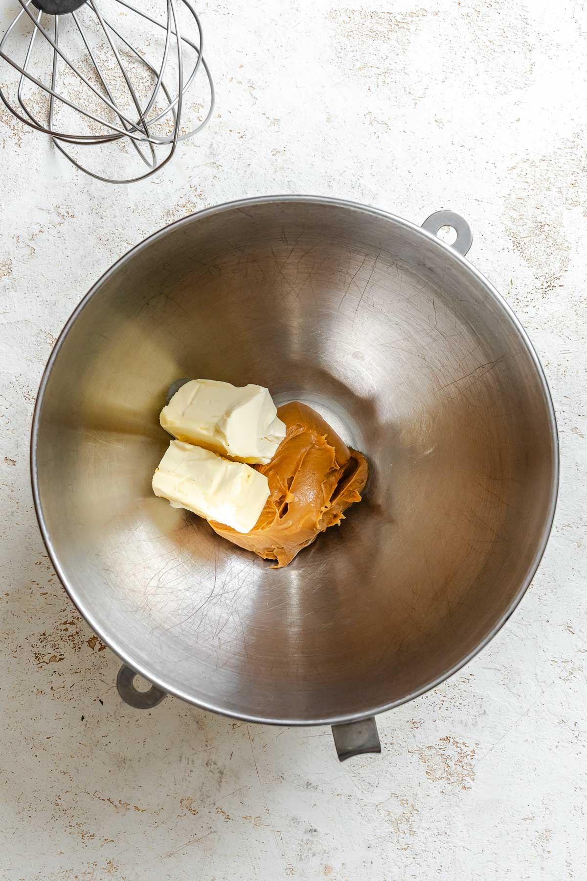 Ingredients for Easy Peanut Butter Frosting added to a bowl.