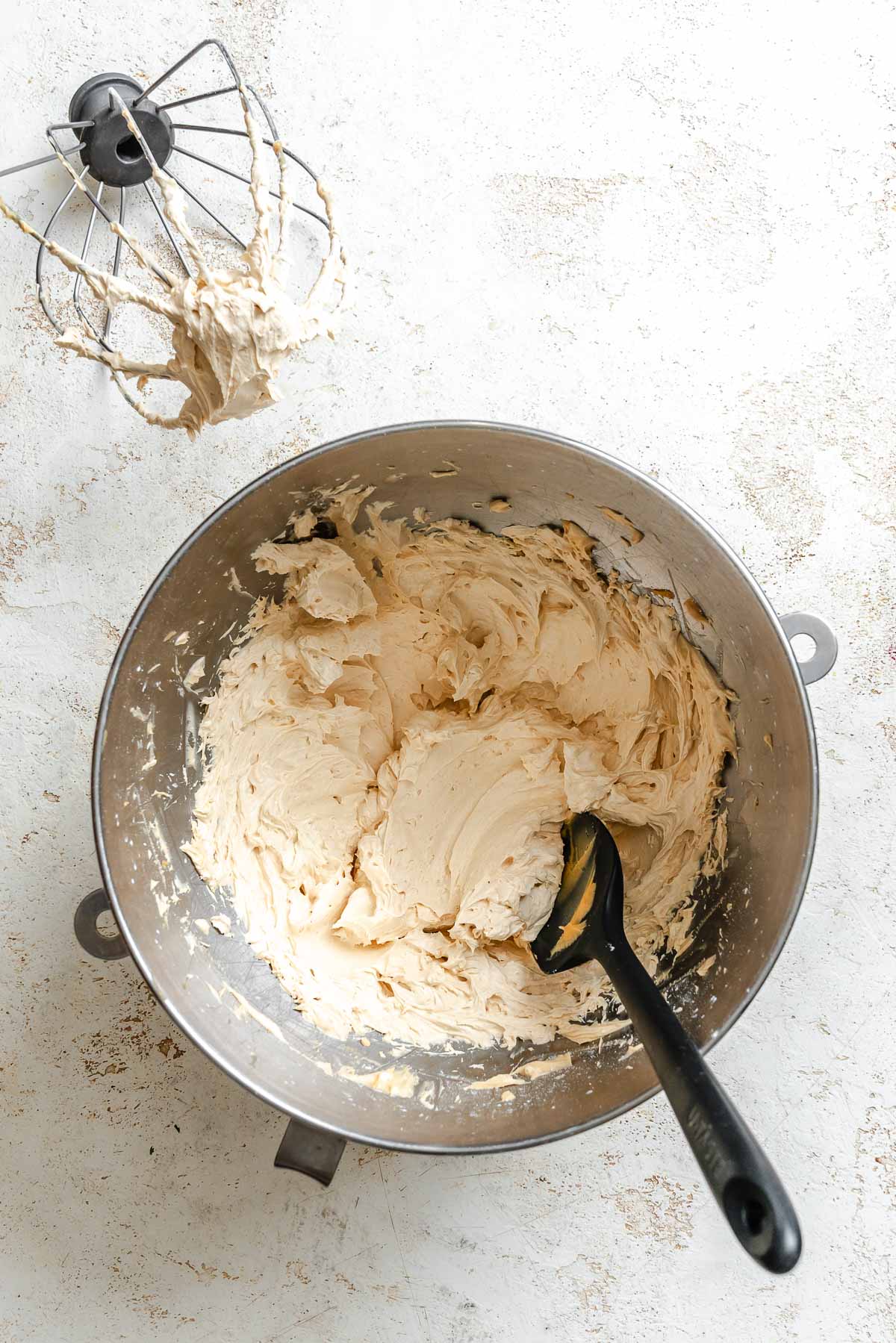 Process shot showing ingredients for Easy Peanut Butter Frosting blended in bowl.