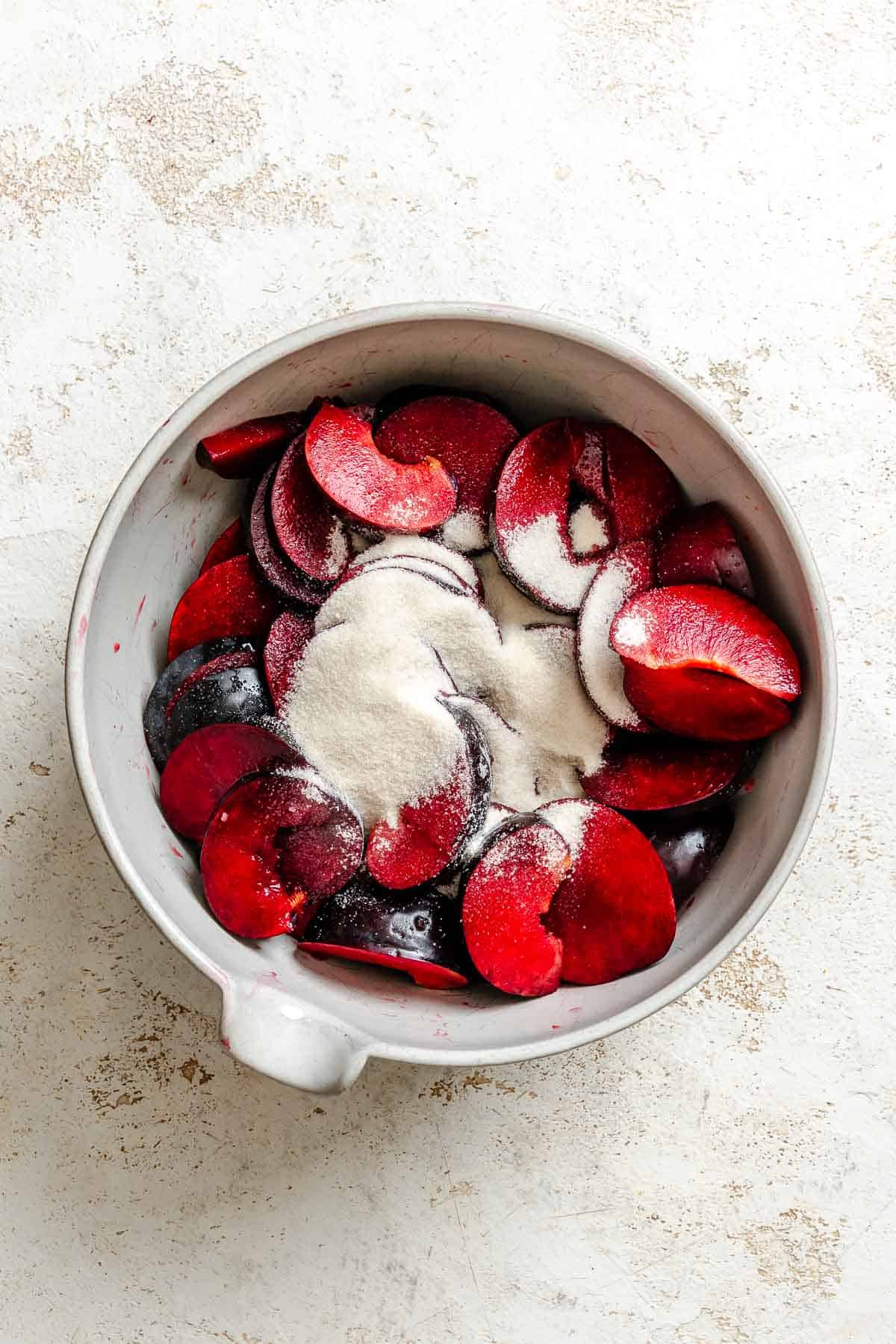 Process shot showing ingredients in a bowl for Easy Plum Tart (Plum Galette).