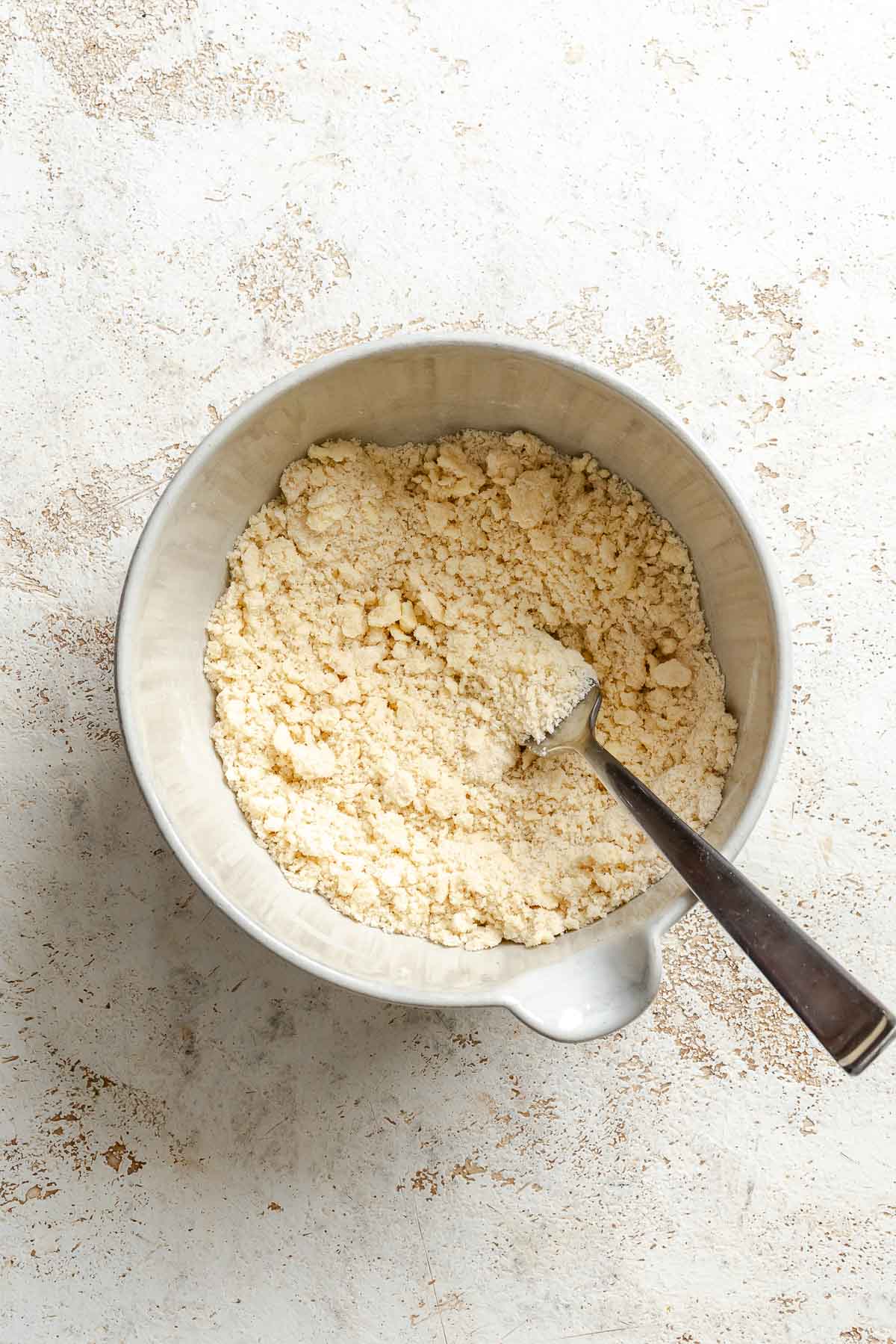 Process shot showing mixing ingredients in a bowl.