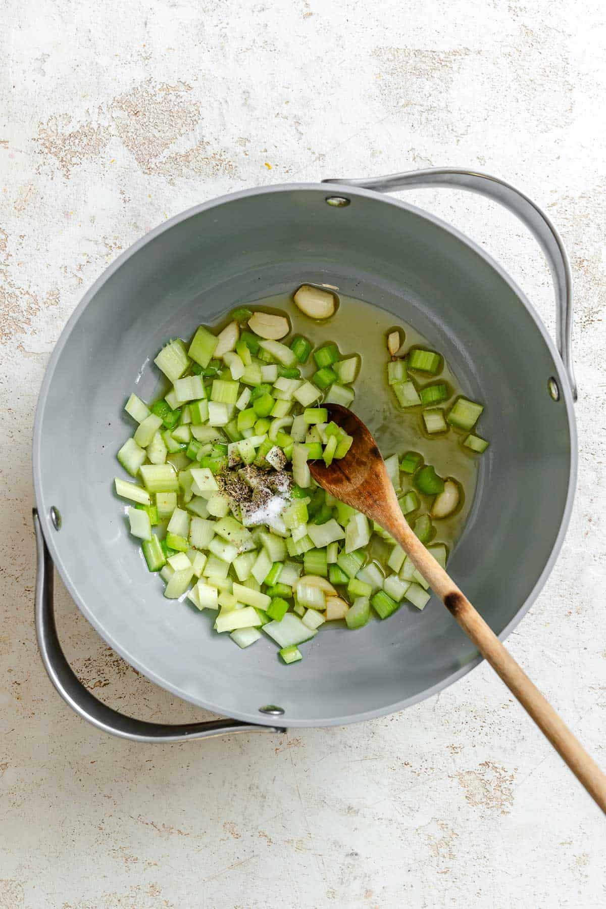 Process shot showing mixing ingredients in a pan.