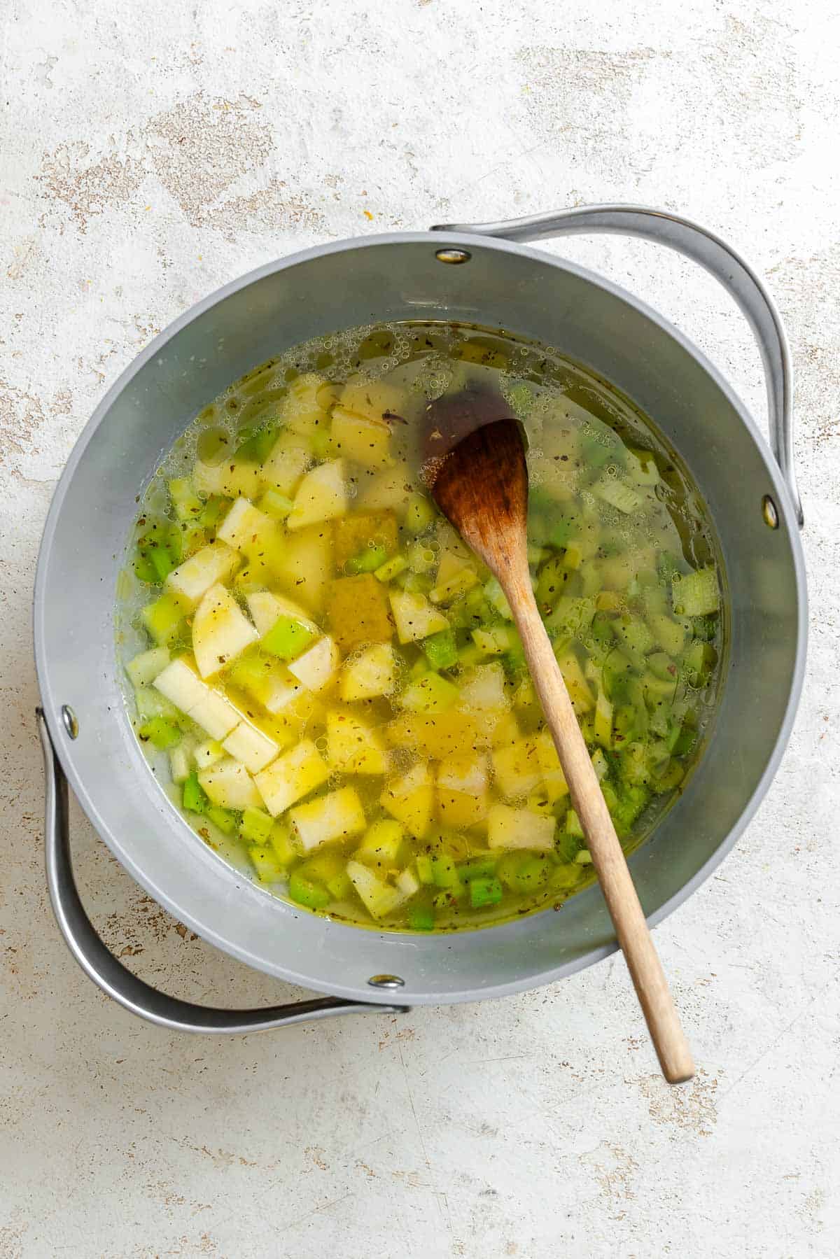 Process shot showing mixing ingredients in a pan.