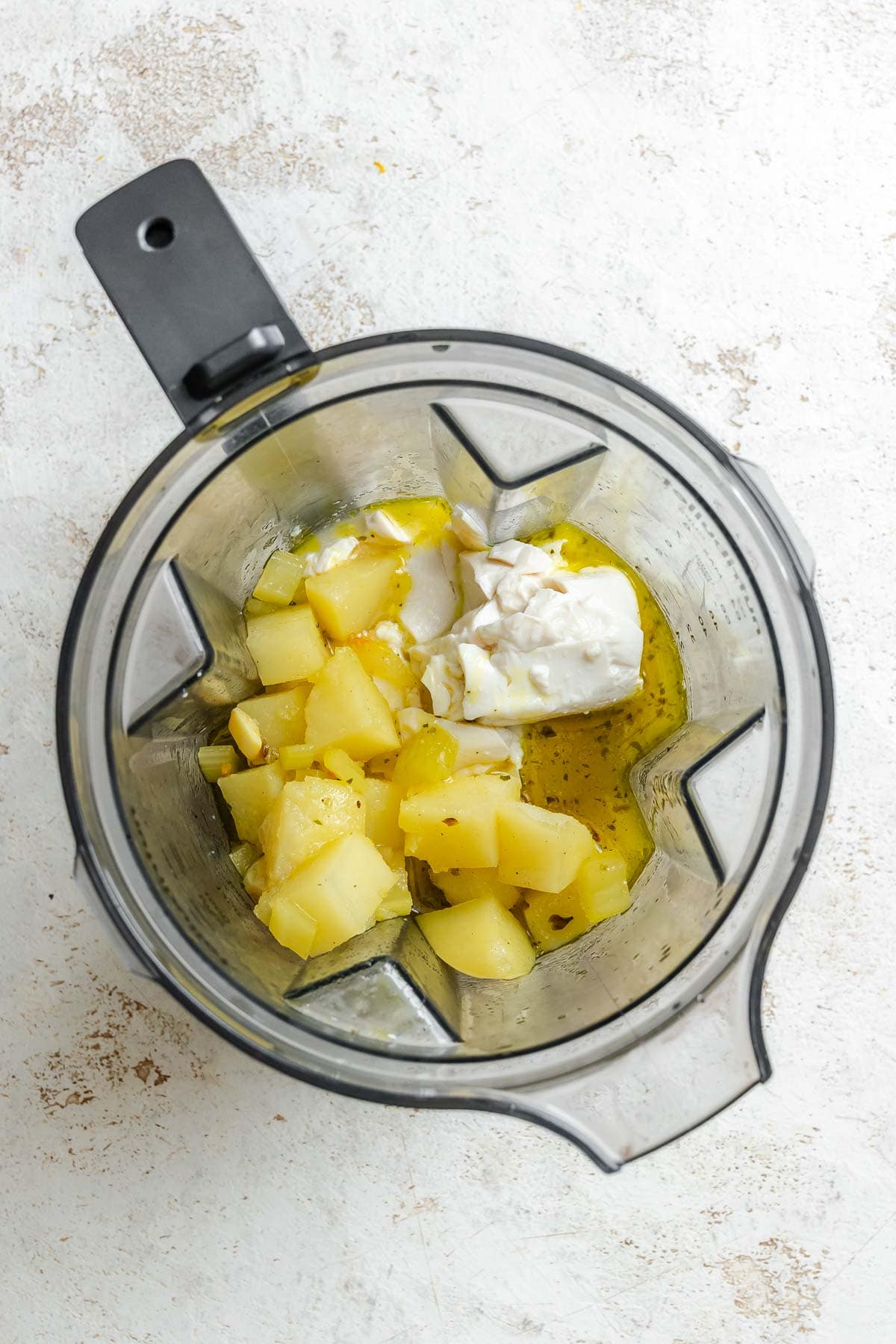 Process shot showing ingredients added to a blender.