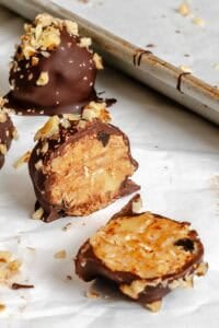 Completed Chocolate Covered Peanut Butter Balls (+ Add-Ins) on a baking sheet.