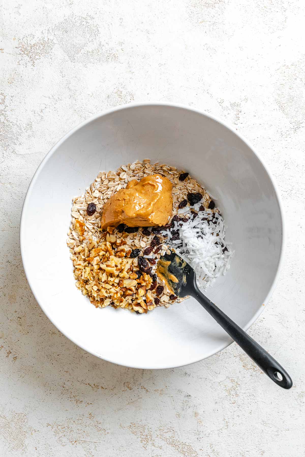 Process shot showing mixing ingredients together in a bowl.