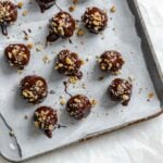 Completed Chocolate Covered Peanut Butter Balls (+ Add-Ins) on a baking sheet.