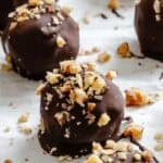 Completed Chocolate Covered Peanut Butter Balls (+ Add-Ins) on a baking sheet.