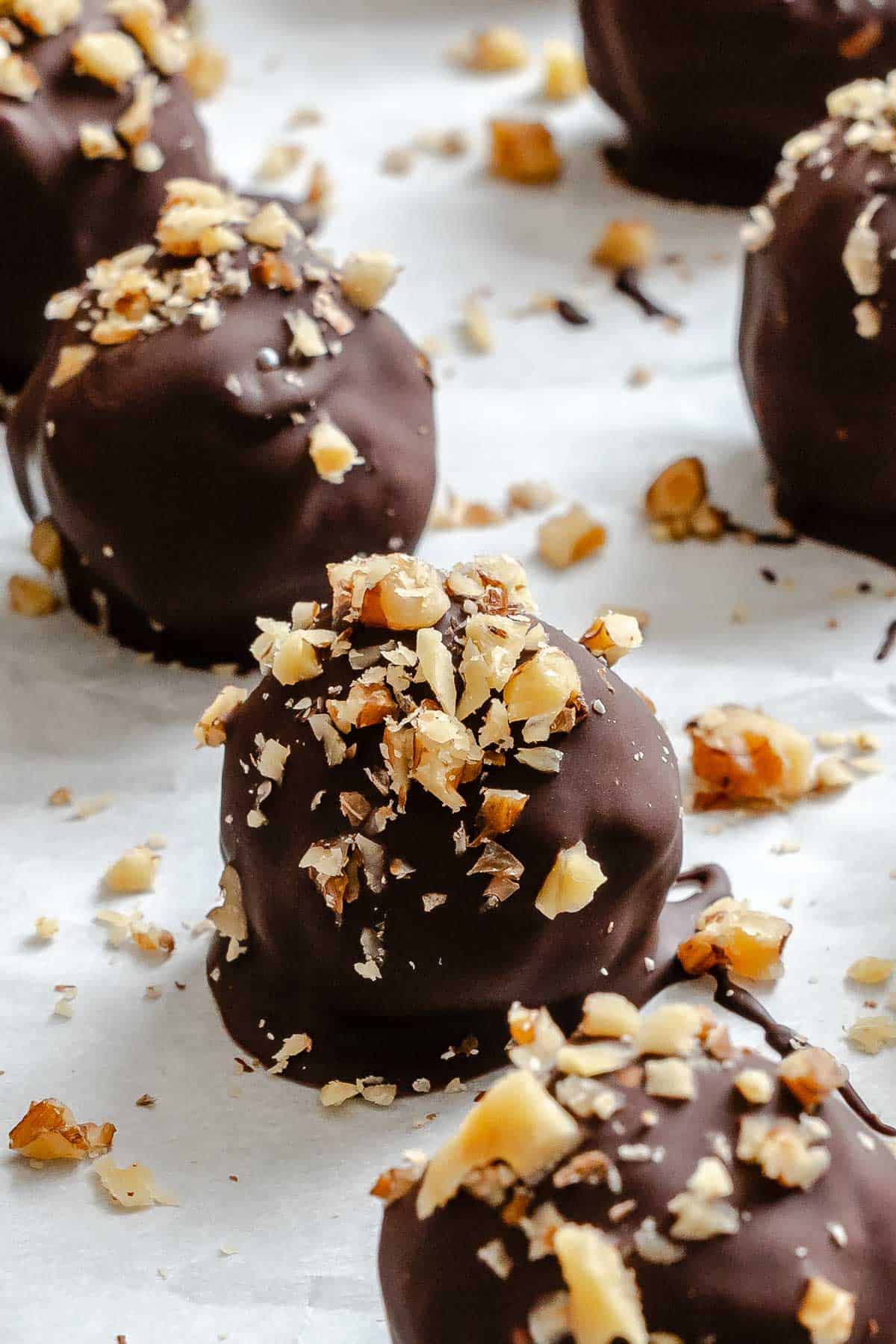 Completed Chocolate Covered Peanut Butter Balls (+ Add-Ins) on a baking sheet.