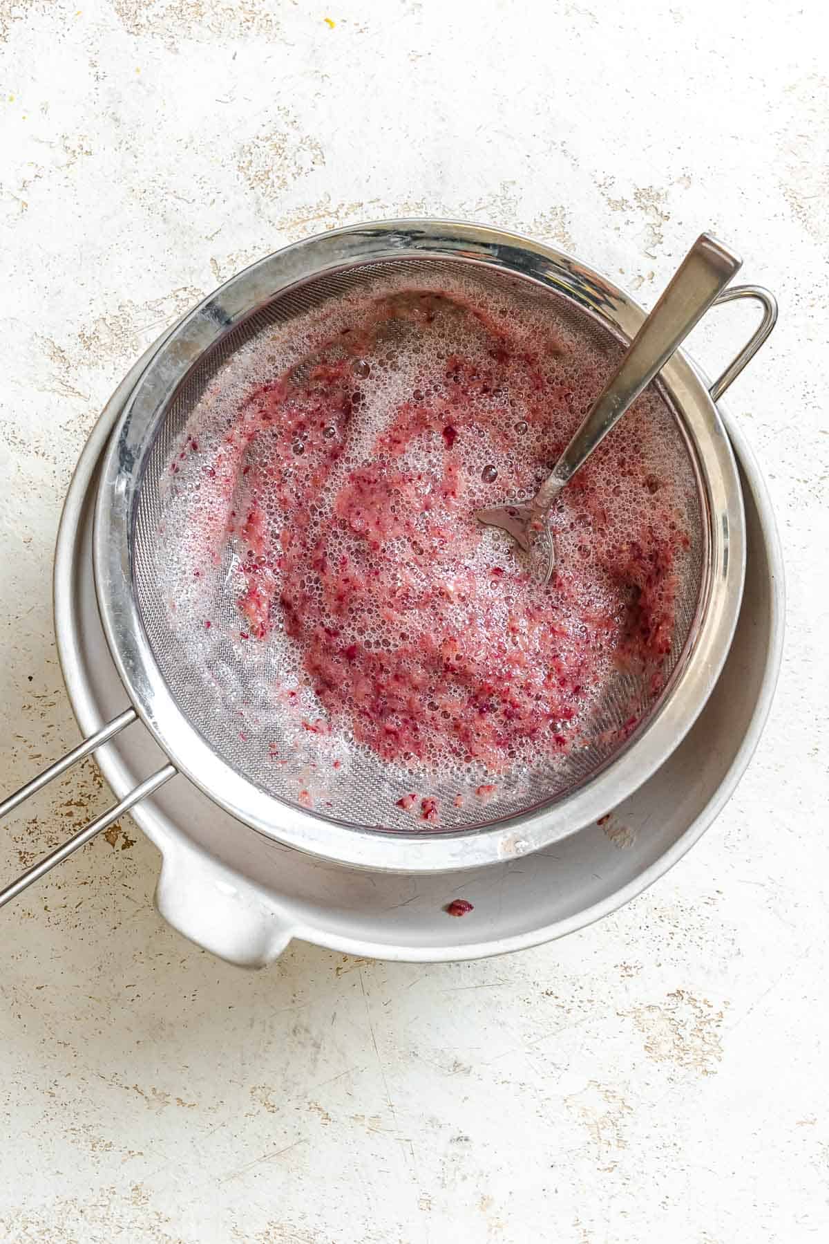 Process shot showing using a fine-mesh sieve for the blended grapes.