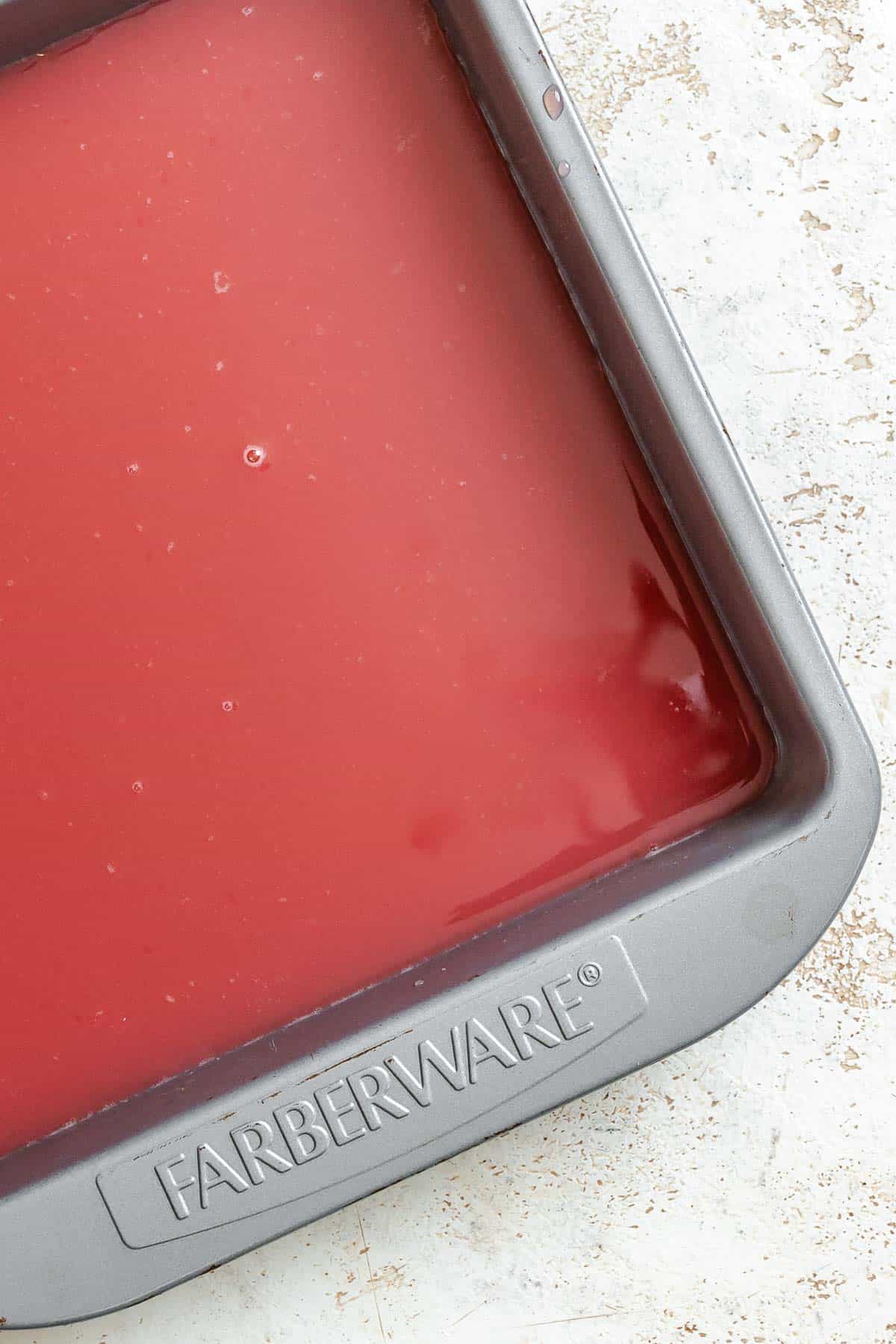 Process shot showing ingredients added to baking dish.