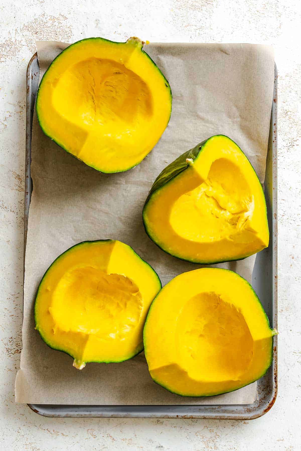 Process shot showing Kabocha Squash on a baking tray.