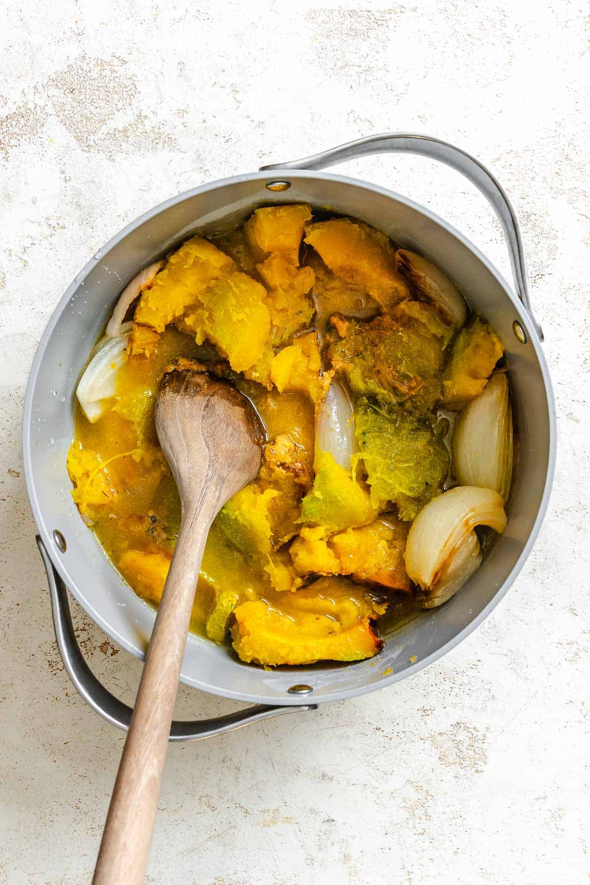 Process shot showing ingredients being stirred in a pot.
