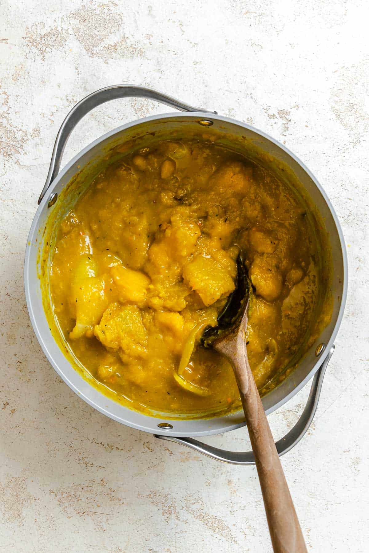 Process shot showing ingredients being stirred in a pot.