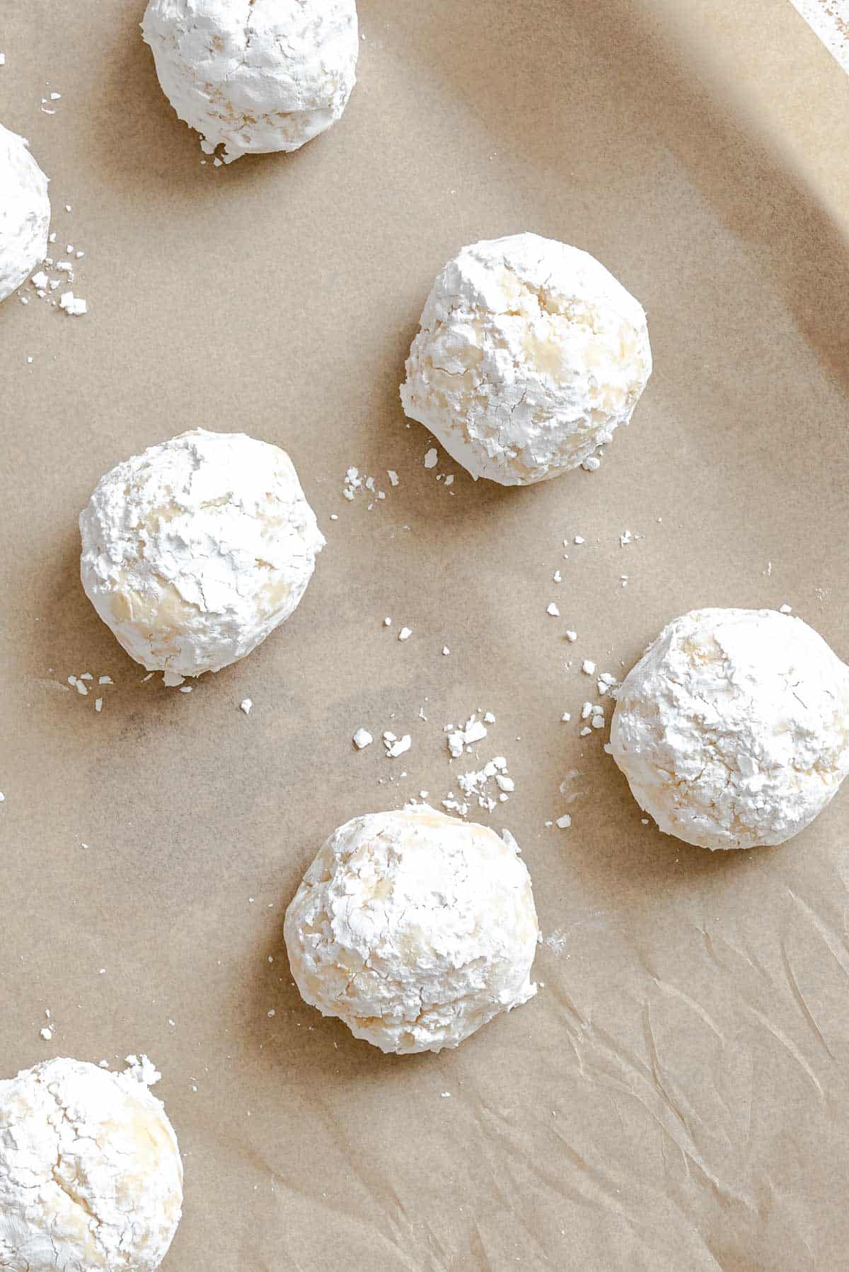 Process shot showing balls of dough on baking sheet.