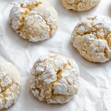 Completed Lemon Crinkle Cookies on a white surface.