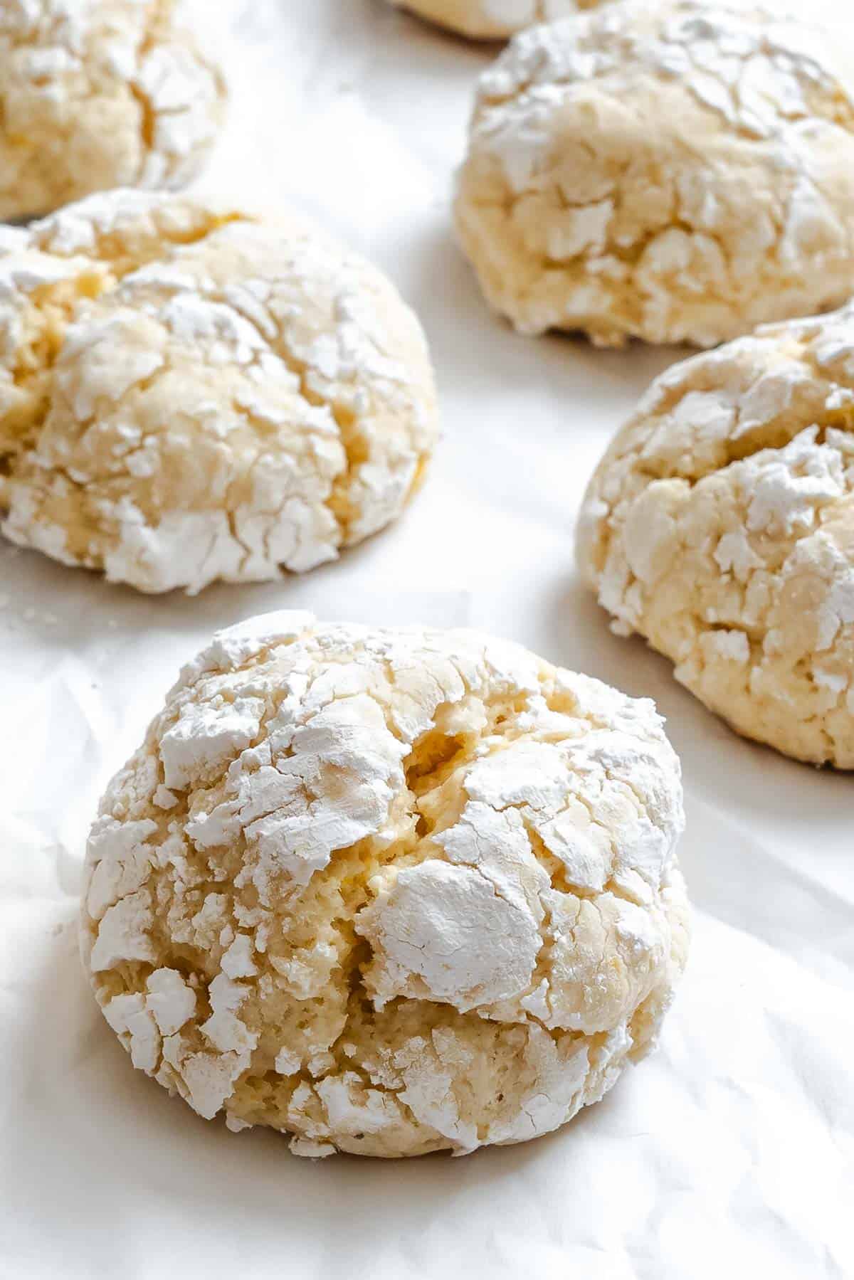Completed Lemon Crinkle Cookies on a white surface.