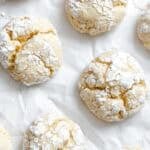 Completed Lemon Crinkle Cookies on a white surface.