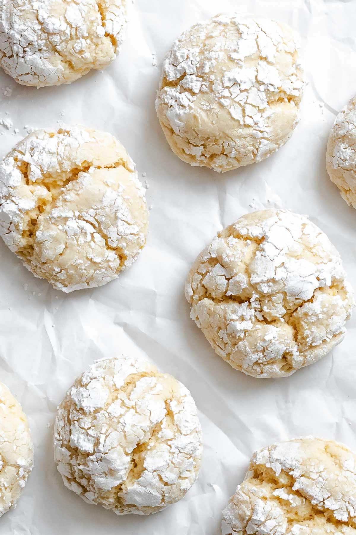 Completed Lemon Crinkle Cookies on a white surface.