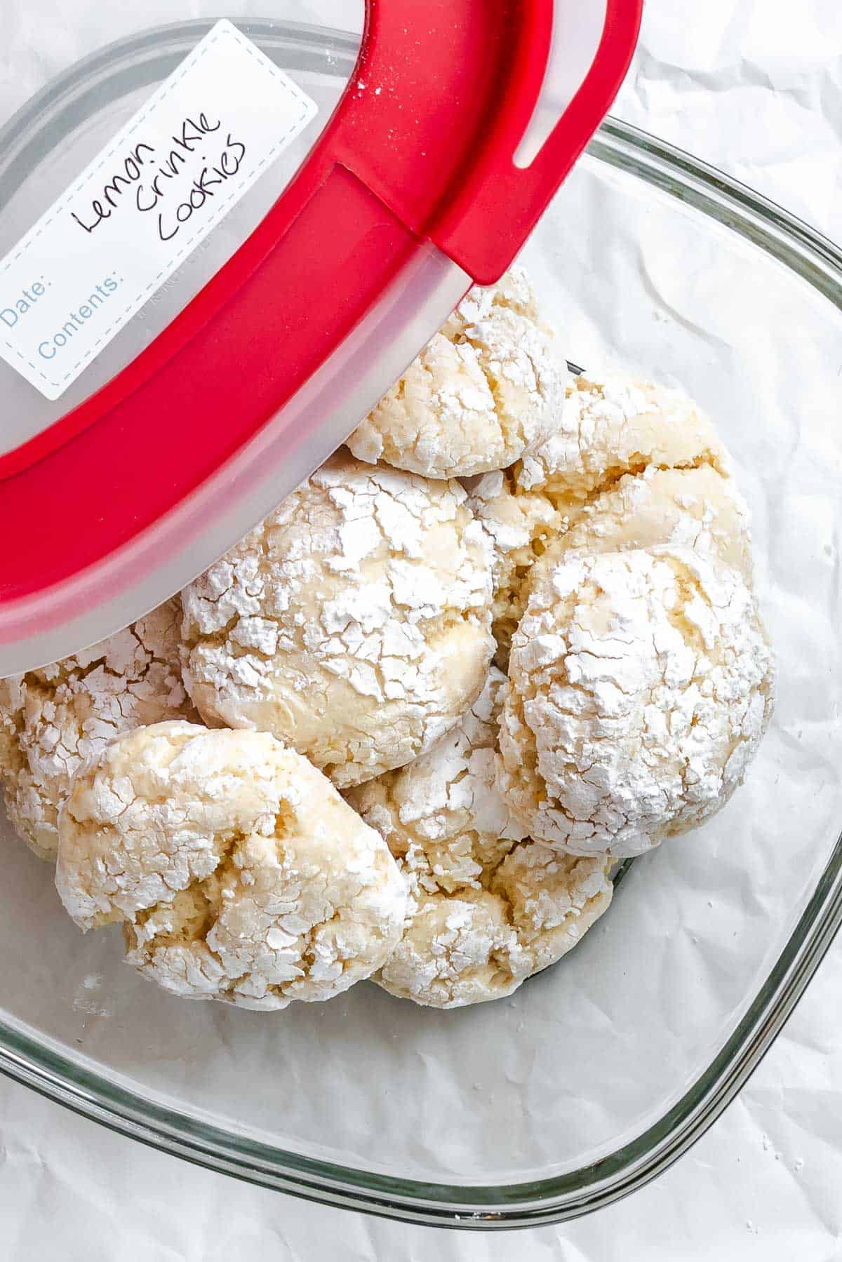 Completed Lemon Crinkle Cookies in a storage container.
