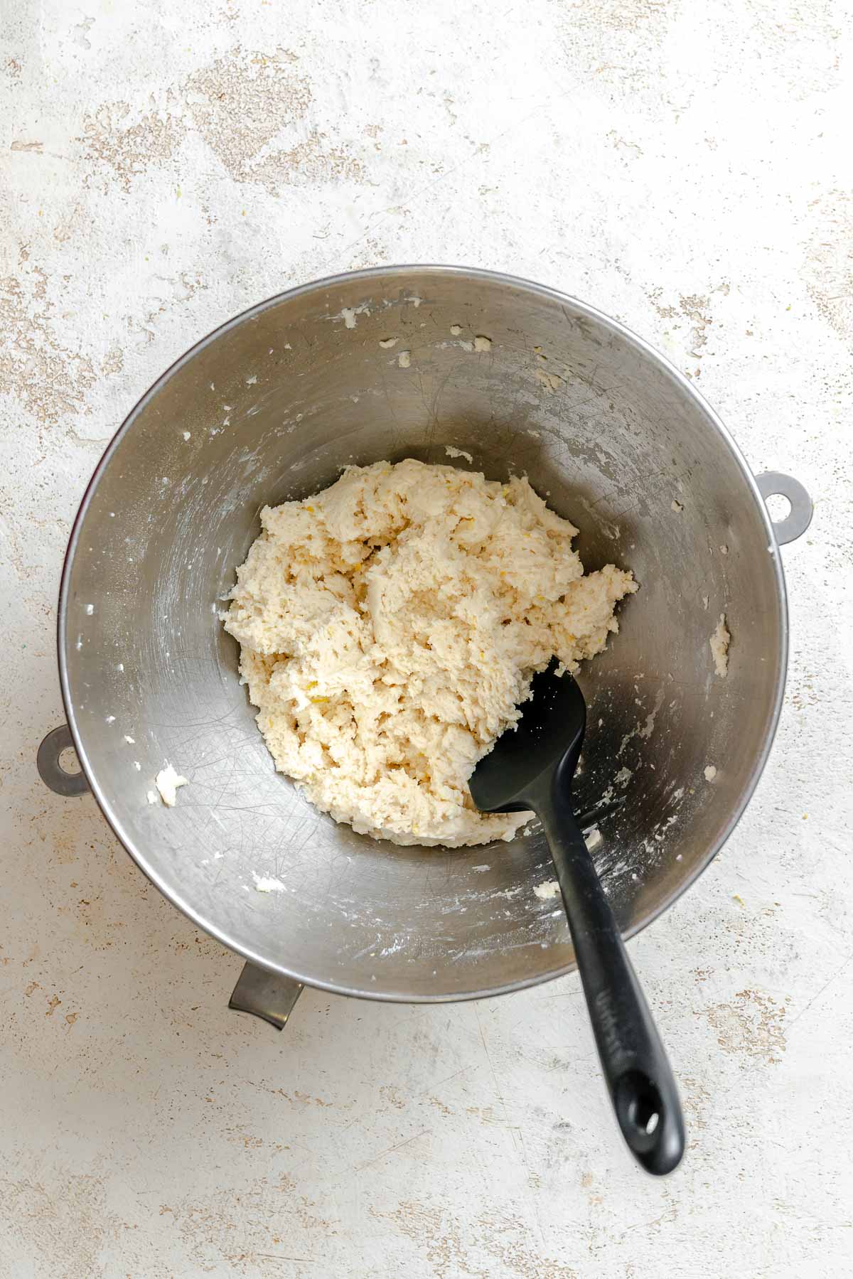 Process shot showing mixing ingredients together in a bowl.