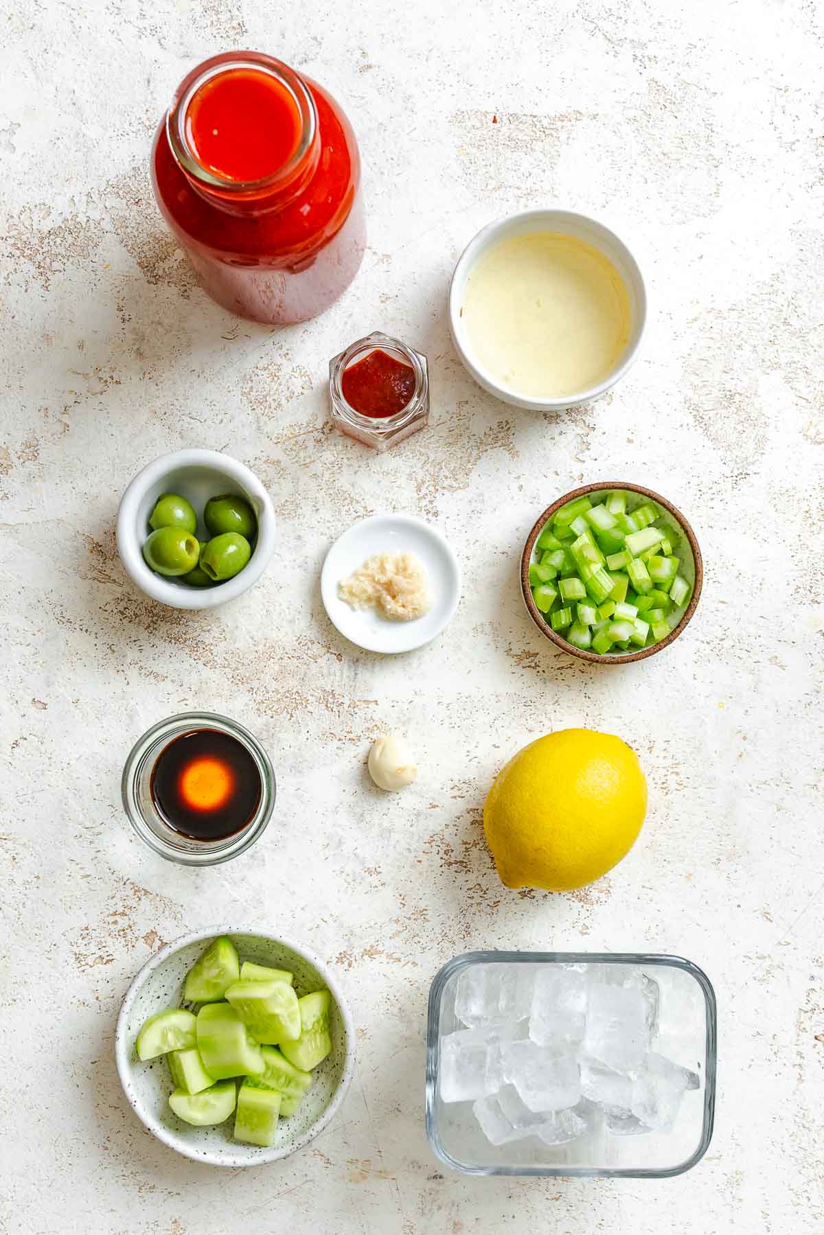 Ingredients for Virgin Bloody Mary measured out on a white surface.