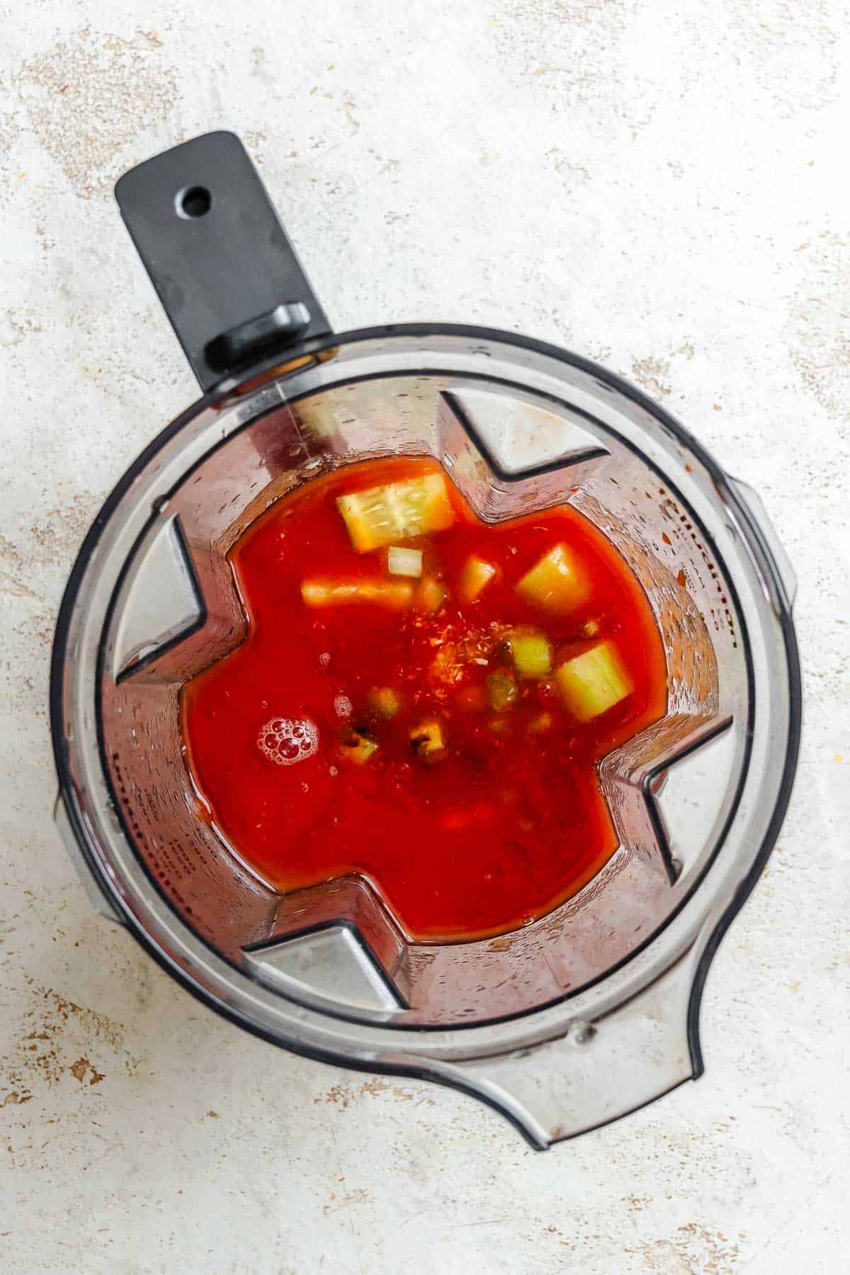Process shot showing ingredients added to a blender.