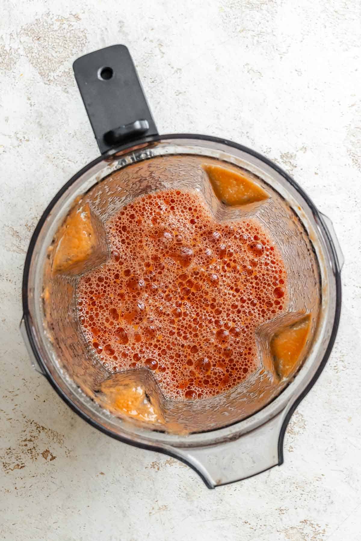 Process shot showing post blended ingredients in a blender.