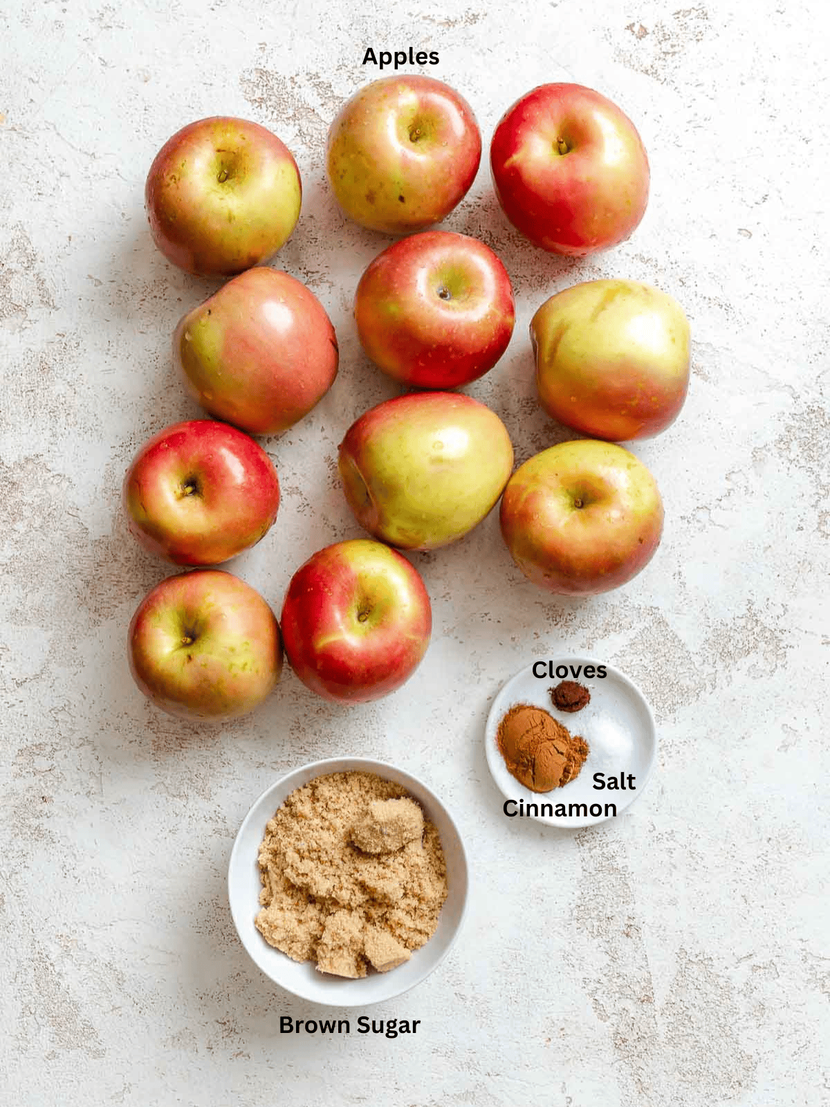 Ingredients for Instant Pot Apple Butter measured out on a white surface.