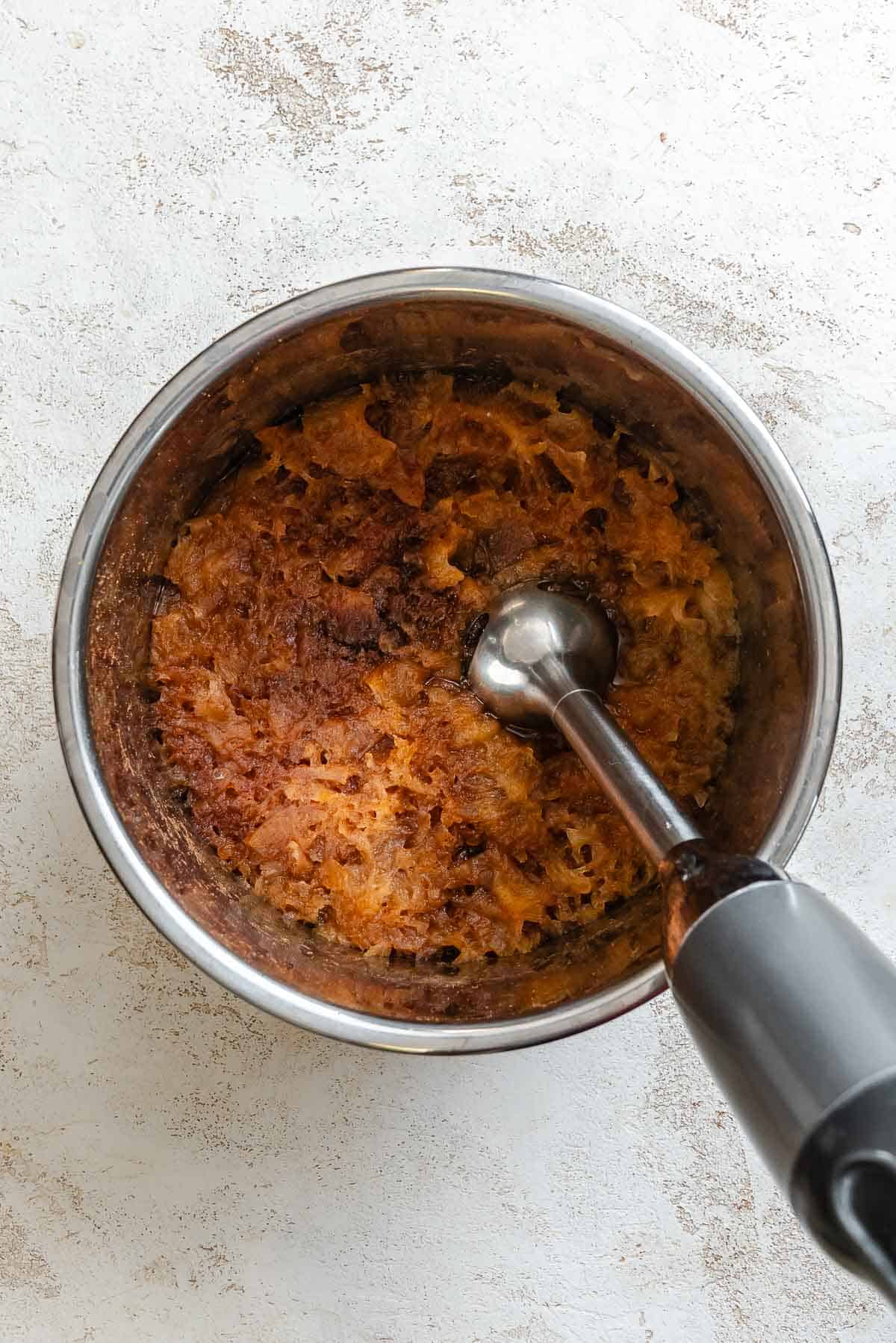 Process shot showing using immersion blender.