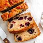 Completed Cranberry Orange Bread (Eggless!) sliced on white surface.