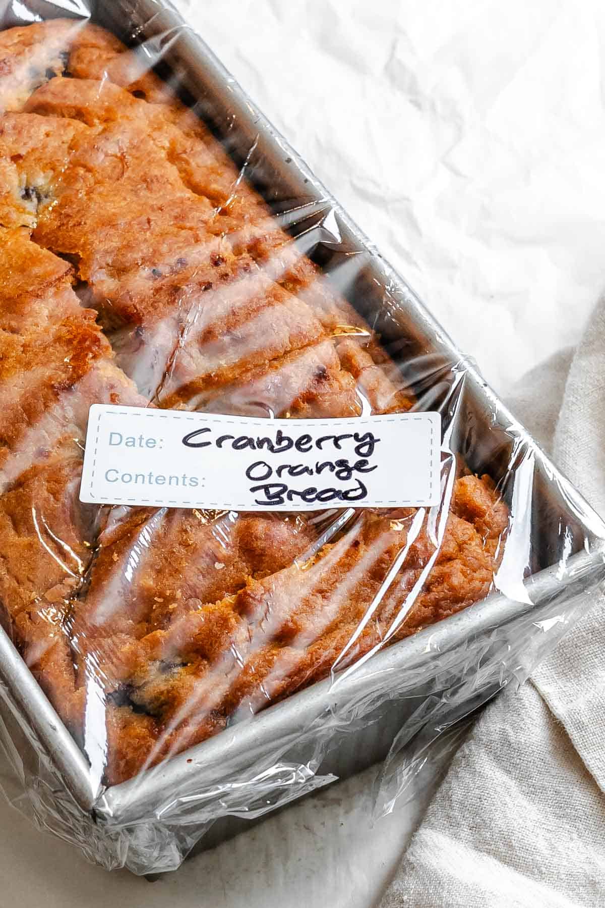 Completed Cranberry Orange Bread (Eggless!) in a storage container.