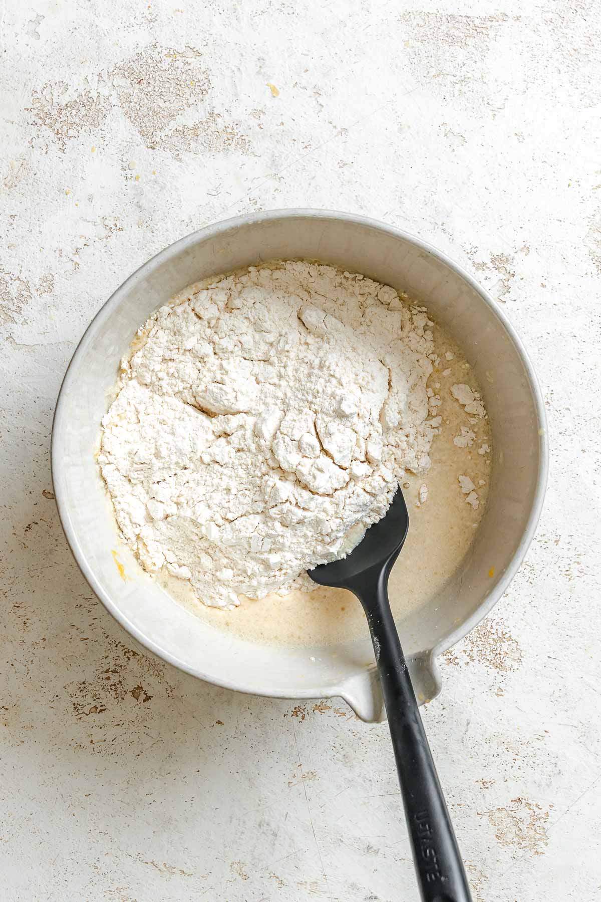 Process shot showing mixing batter in bowl.