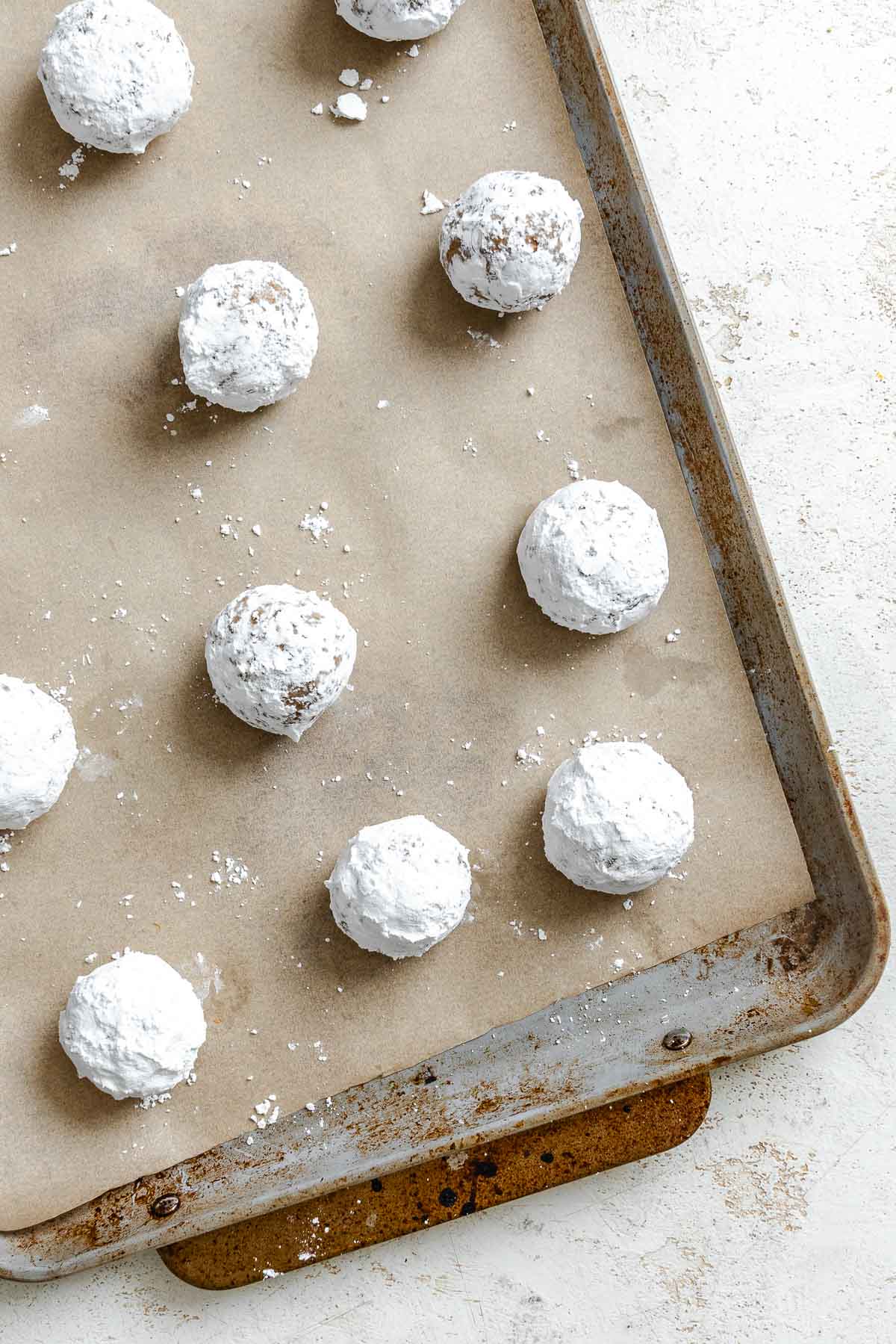 Process shot showing pre-baked cookies on baking dish.